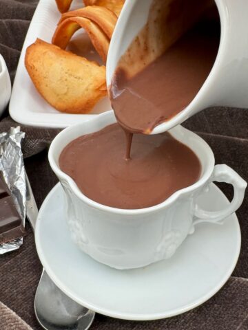 pouring thick homemade hot chocolate from a jug