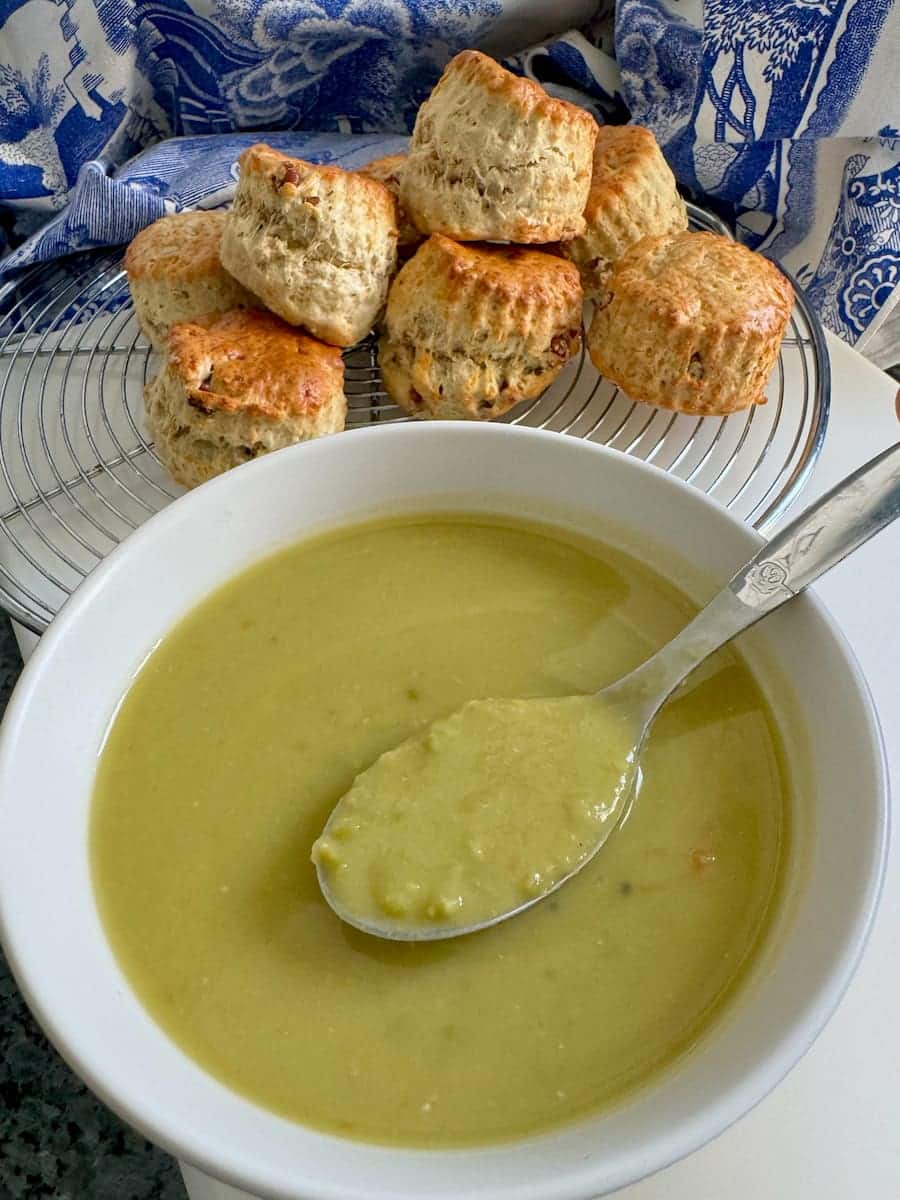large bowl of split pea soup served with cheese scones