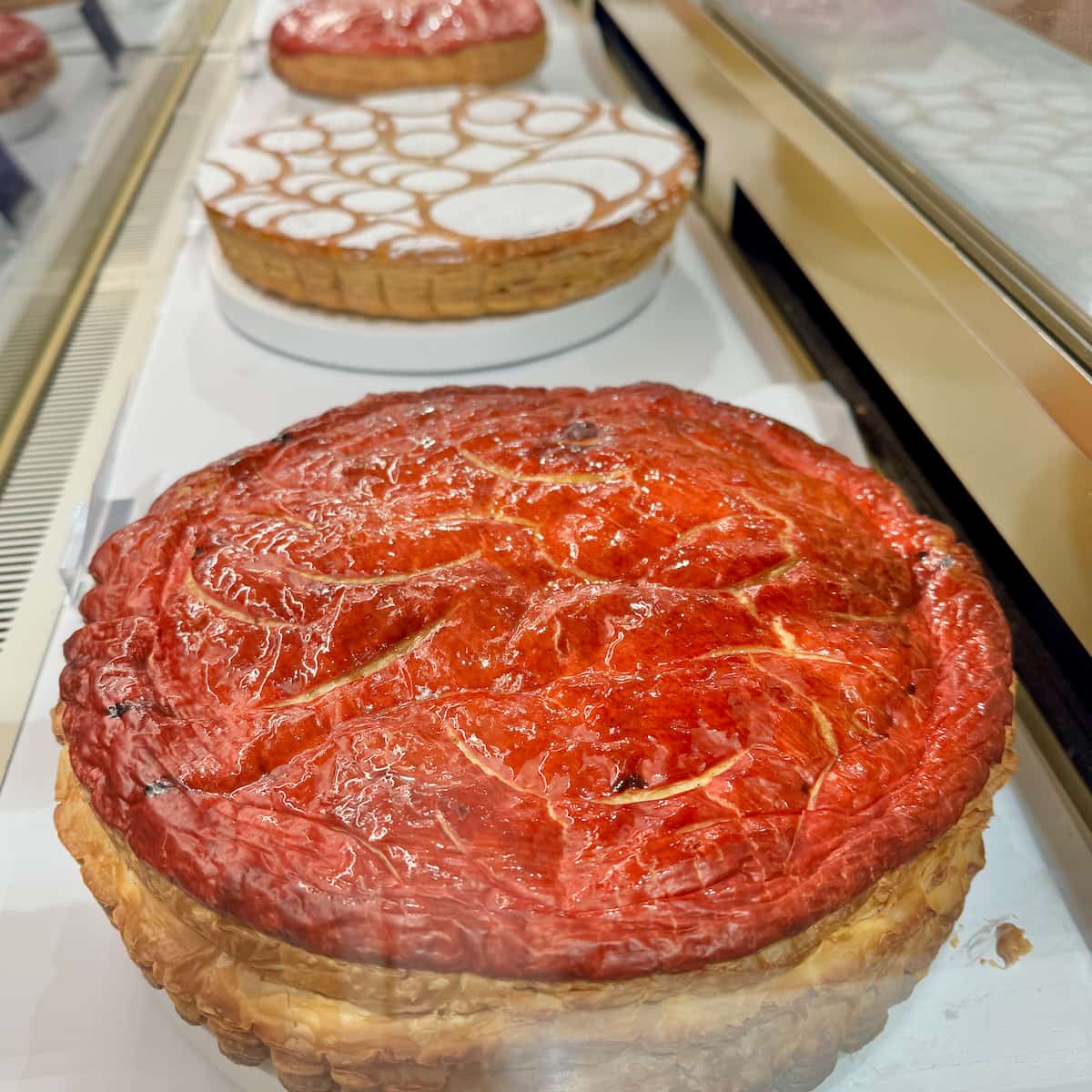 red topped galette of puff pastry cake in the window