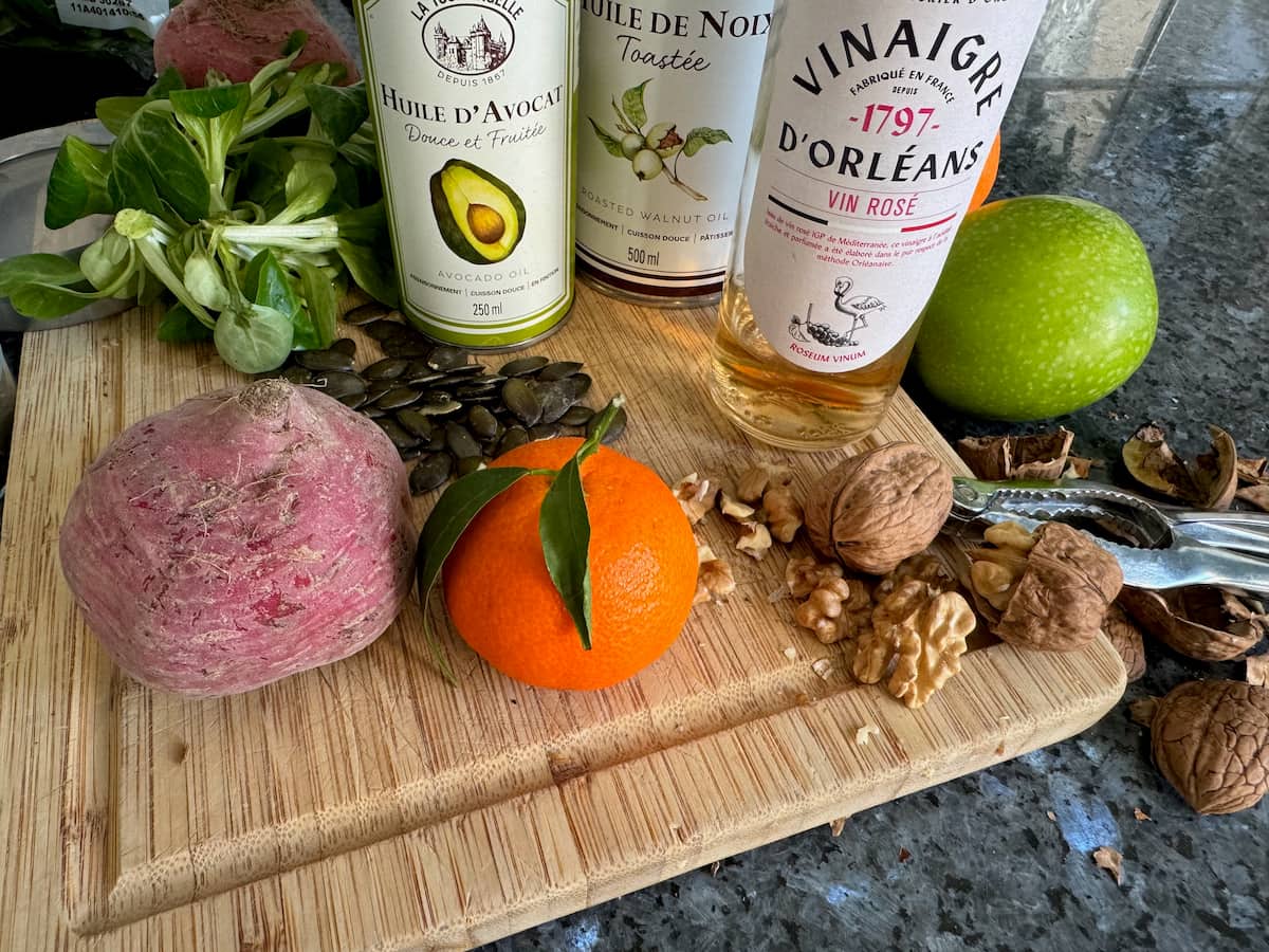 salad dressing ingredients of wine vinegar, avocado oil, orange and nuts