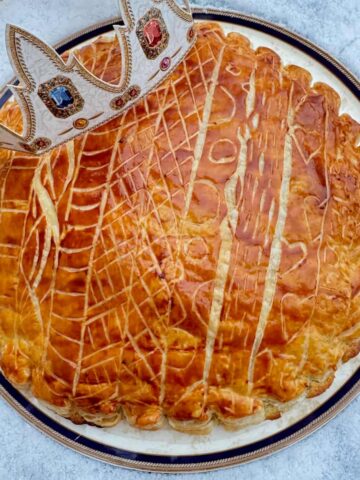 galette des rois French puff pastry almond cake glazed and decorated with a paper crown