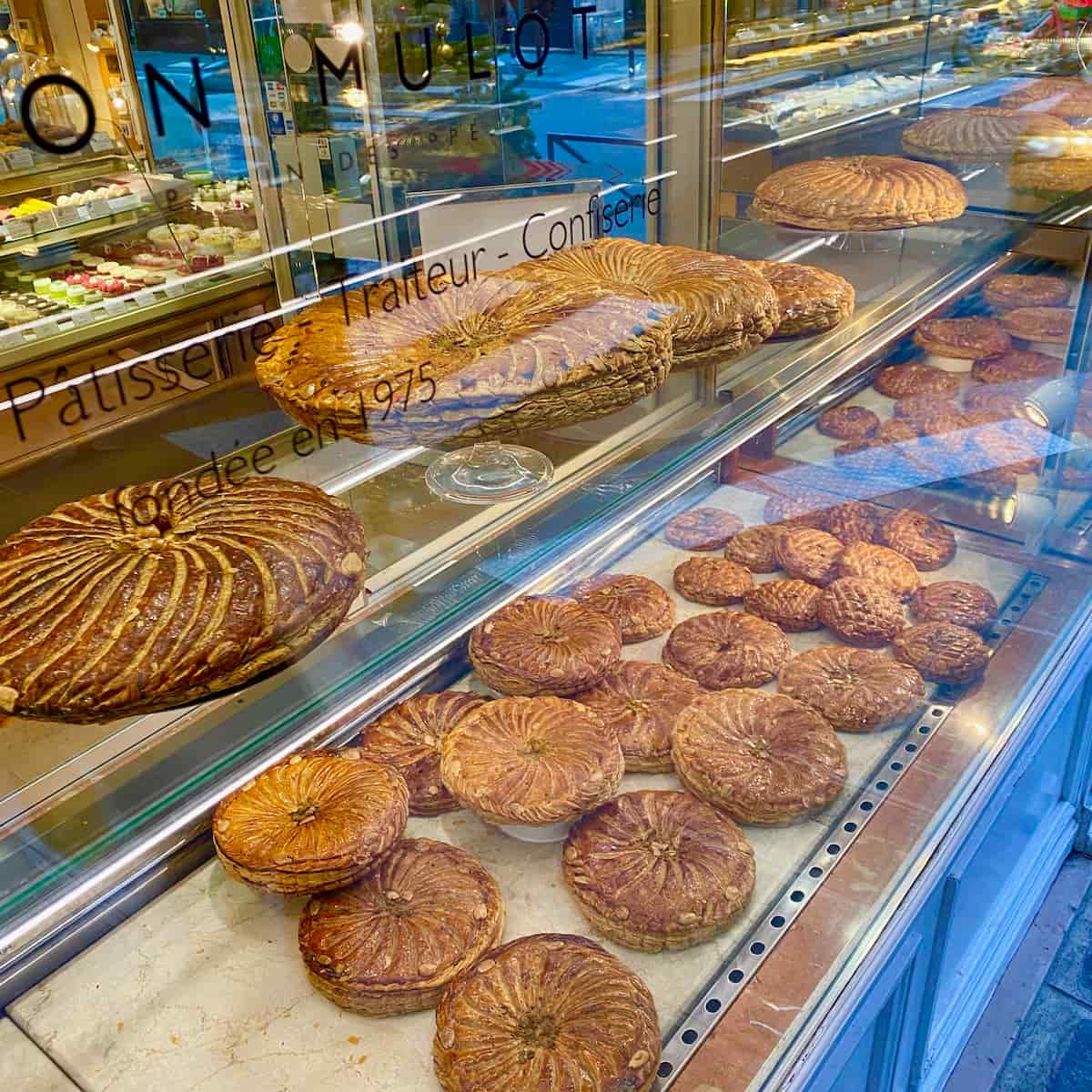 Parisian bakery window filled with galettes des rois King cakes