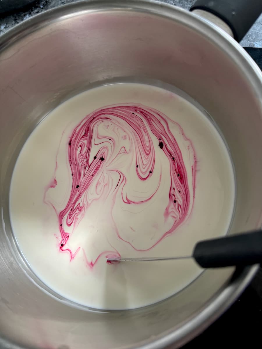 adding rose pink food colouring to cream