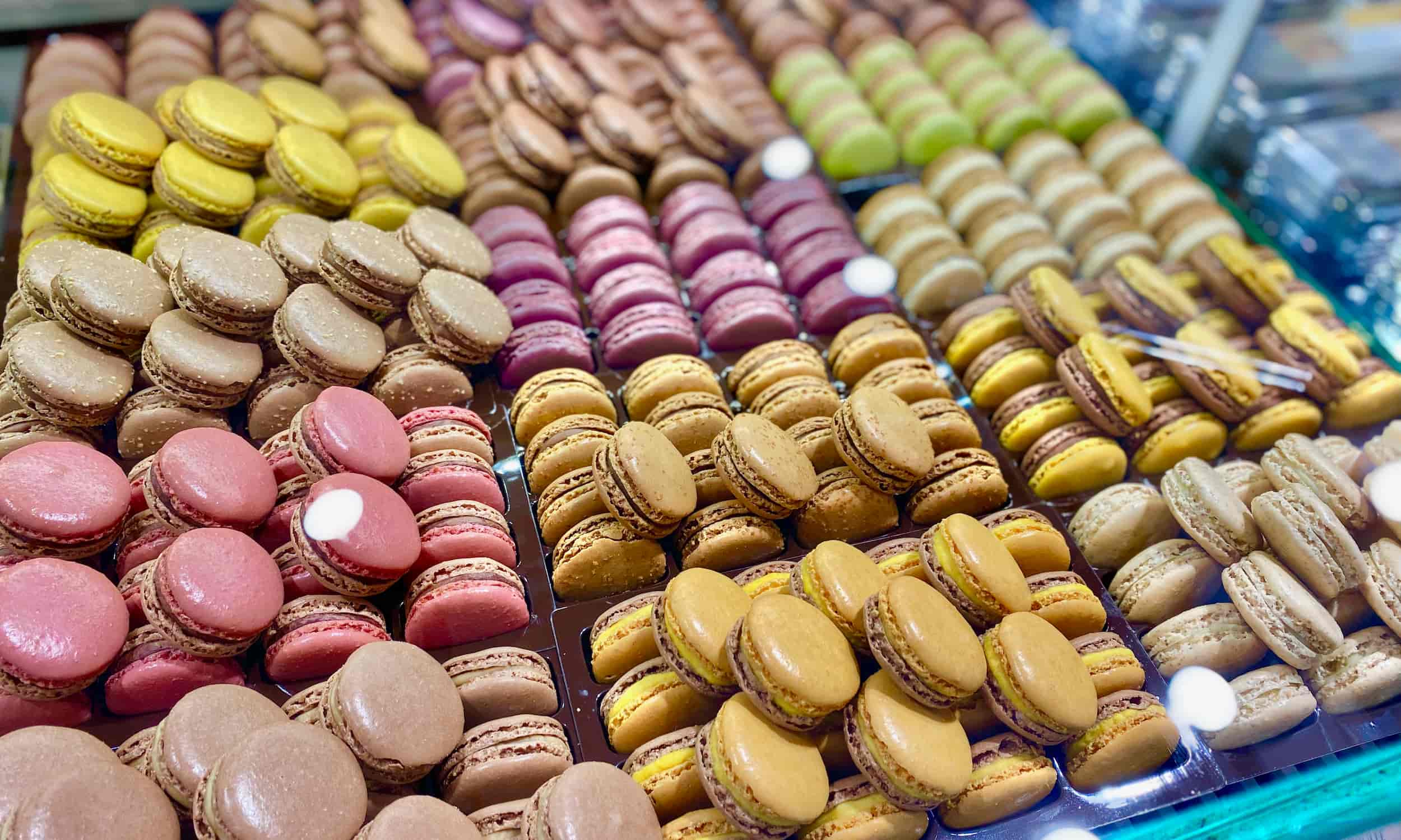 rows of colourful macarons at a pastry shop in Paris