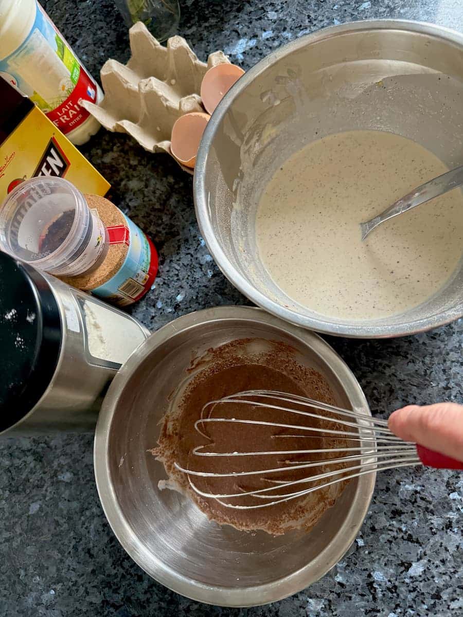 two separate bowls of crepe batter, one with cocoa powder