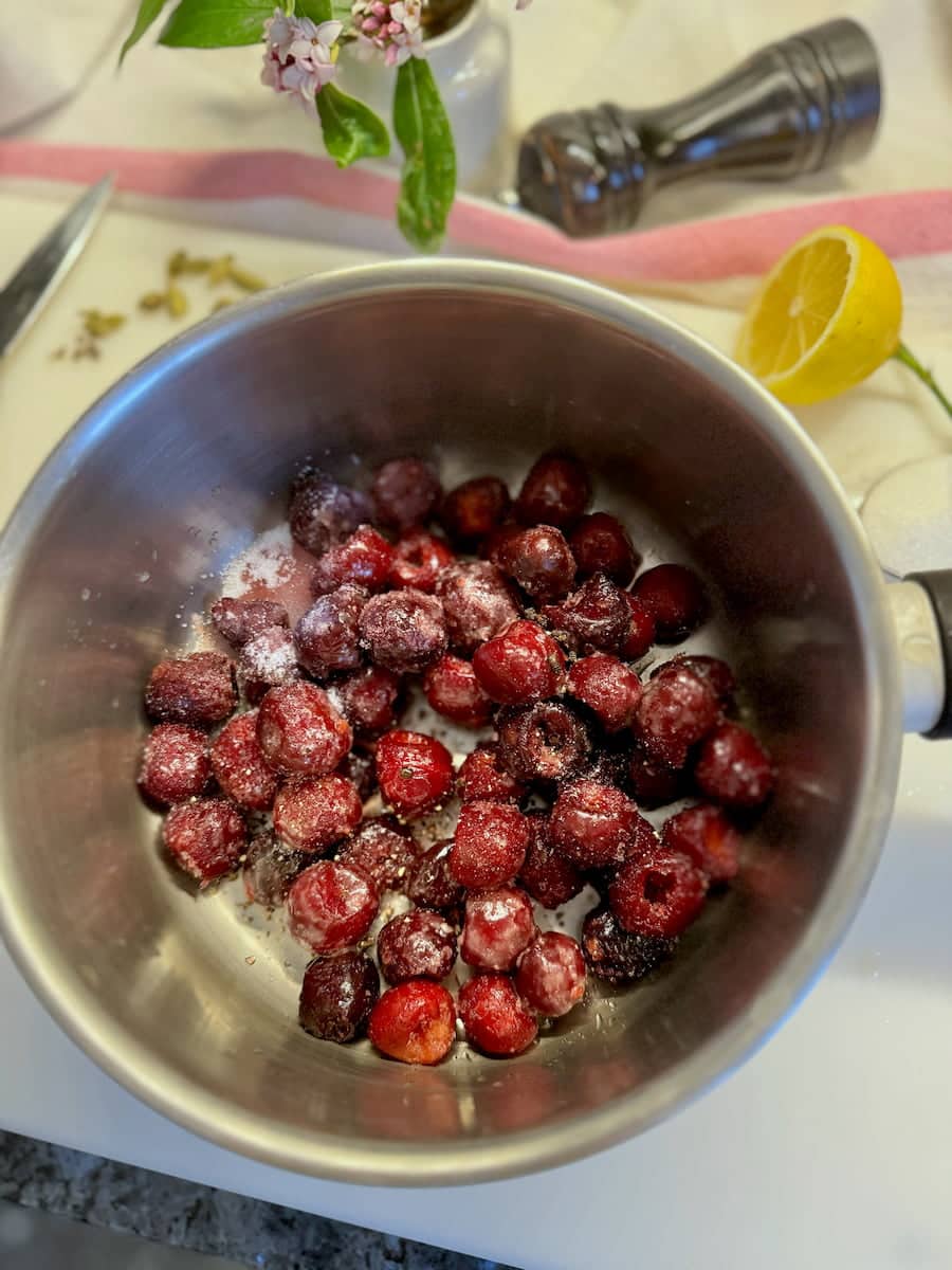 saucepan of frozen cherries and spices to make a sauce