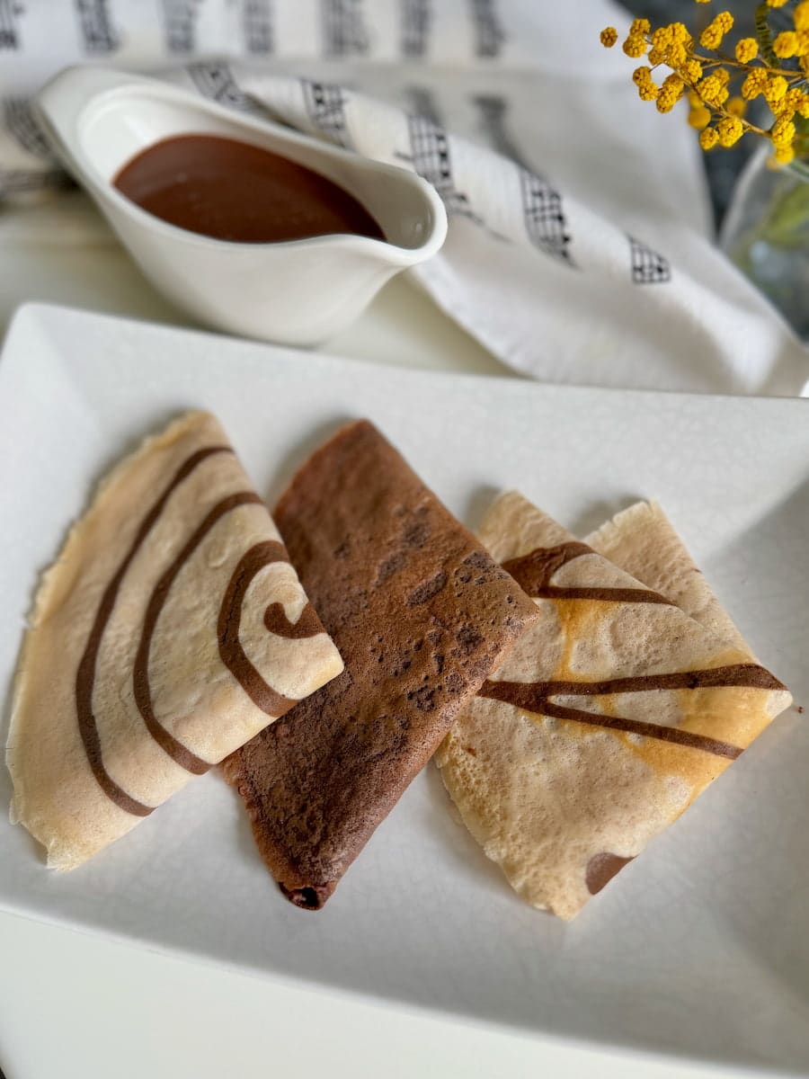 thin chocolate pancakes folded over with spiral designs on them