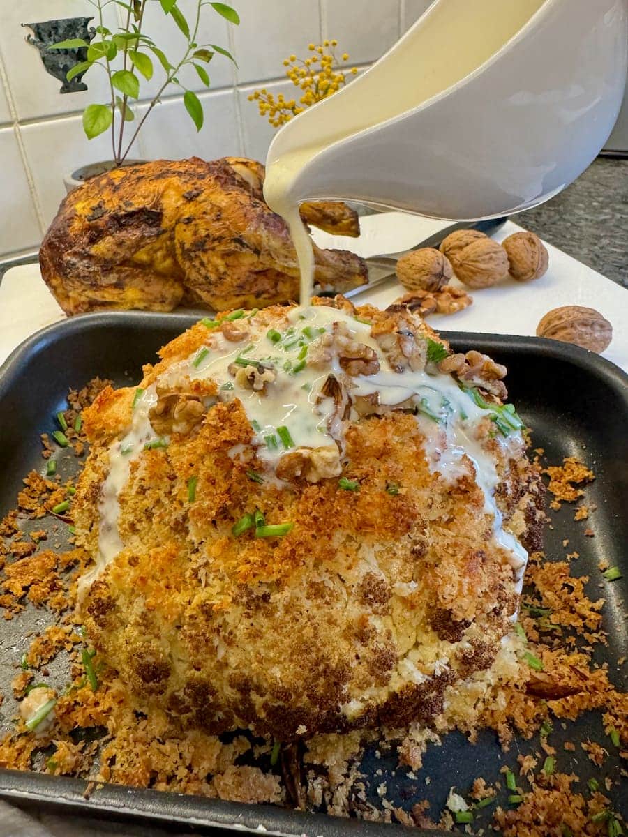 oven roasted whole cauliflower with crispy parmesan topping and cheese sauce