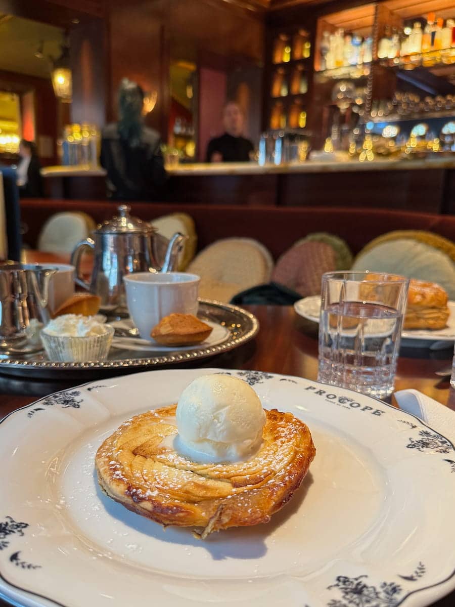 apple tart with ice cream and tea tray at the historical restaurant Le Procope in Paris