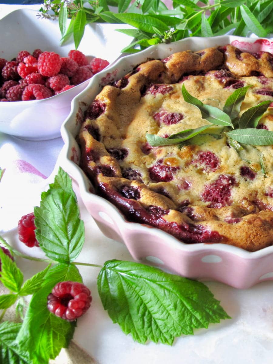 ovenproof dish containing a baked custard with raspberries