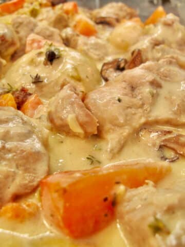 tender veal in a white sauce with vegetables known as a French Blanquette de Veau stew