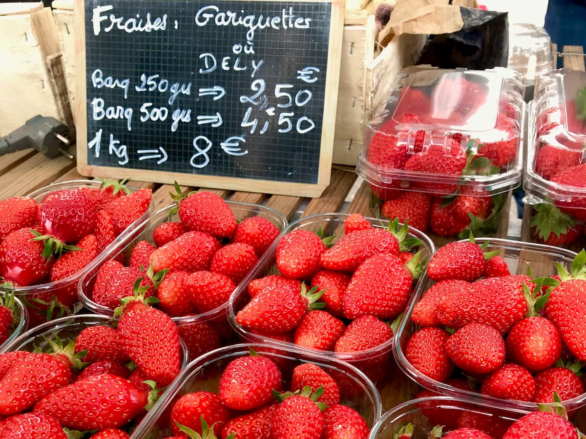 tubs of shiny French gariguette strawberries, long, thin and acidic yet sweet berries