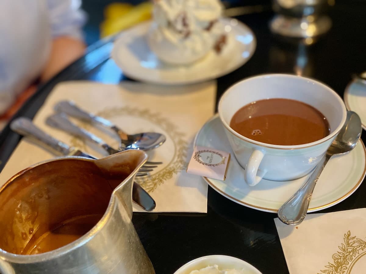 silver jug and porcelain cup filled with hot chocolate in Paris's Laduree