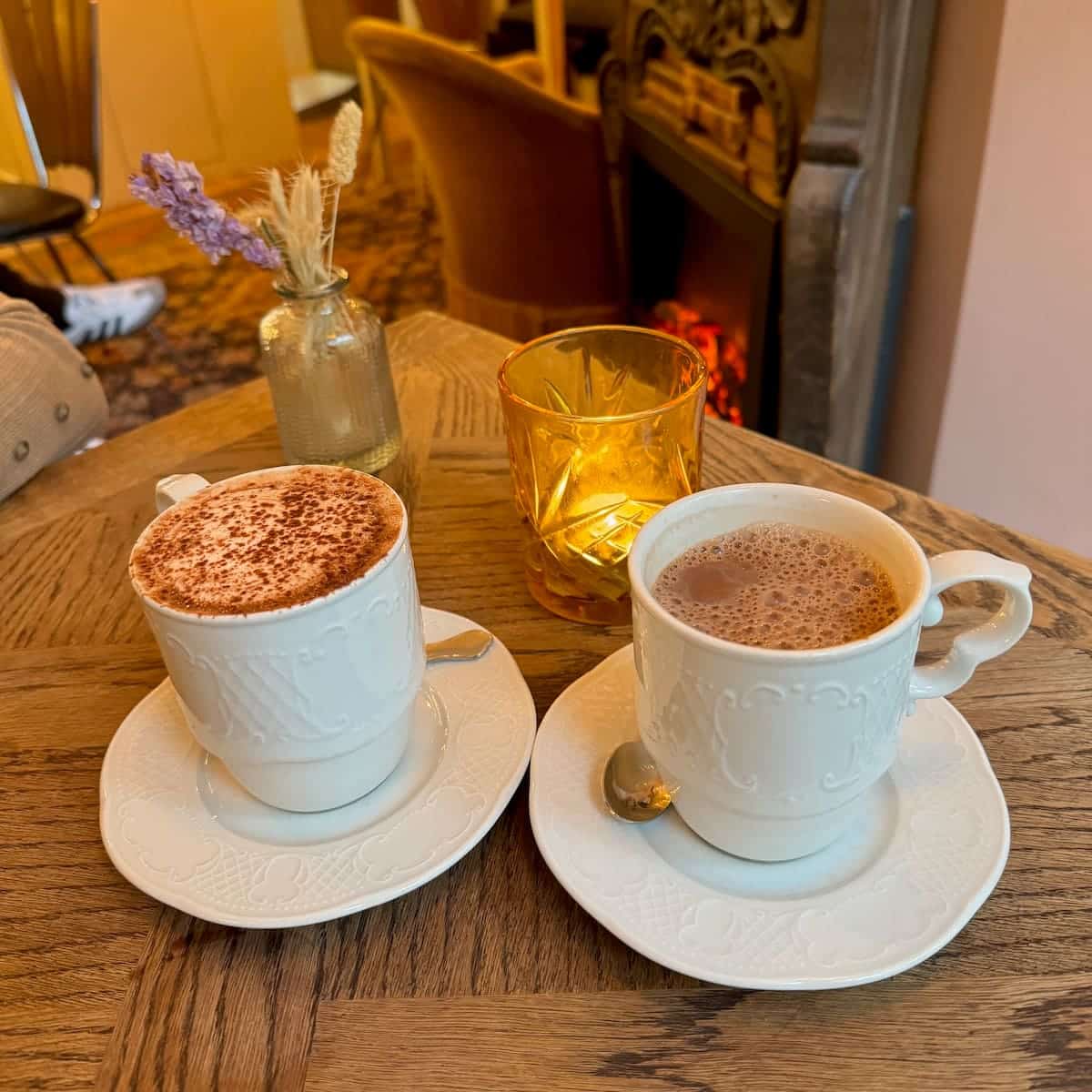 2 cups of hot chocolate in front of the fireplace in a tearoom in Paris Montmartre