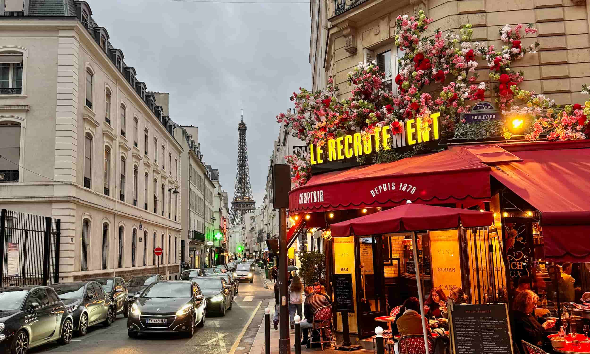 café at dusk on rue saint-Dominique Paris with Eiffel Tower in distance