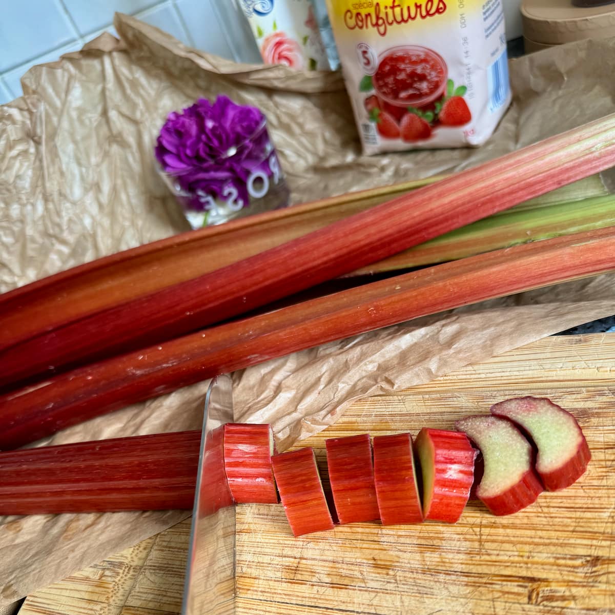 slicing stalks of red rhubarb, jam sugar with pectin and rosewater