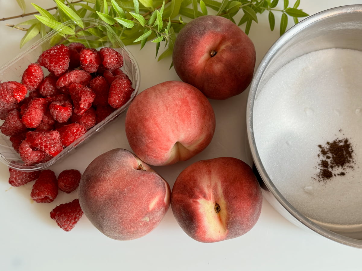 4 white peaches, punnet of raspberries, a pan of sugar with some vanilla bean powder and optional lemon verbena leaves