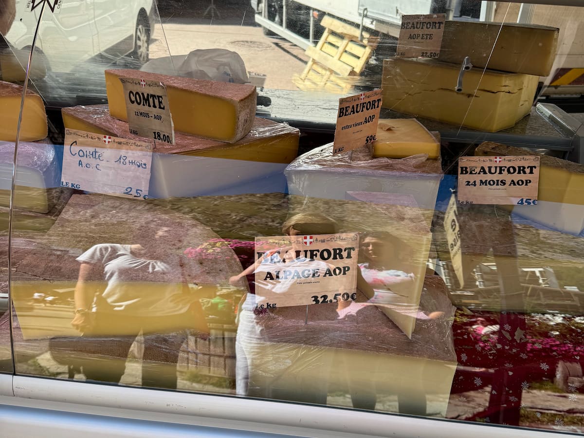 savoyard cheeses with different aged Beaufort and Gruyere in a shop window