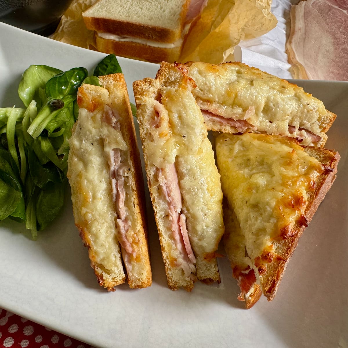 cheese and ham hot sandwich, sliced in half to see the soft insides and toasted texture on top