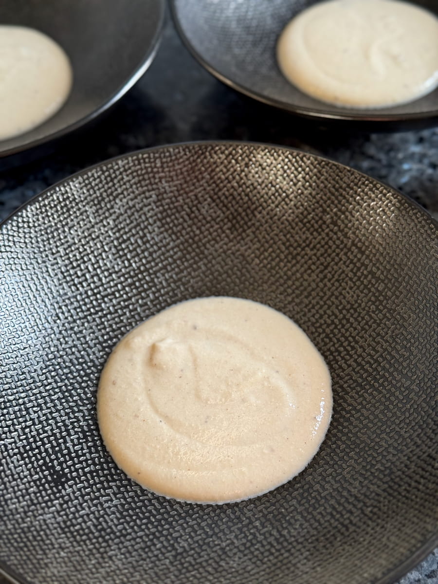 3 serving bowls with a a few spoonfuls of creamy parmesan sauce as a base