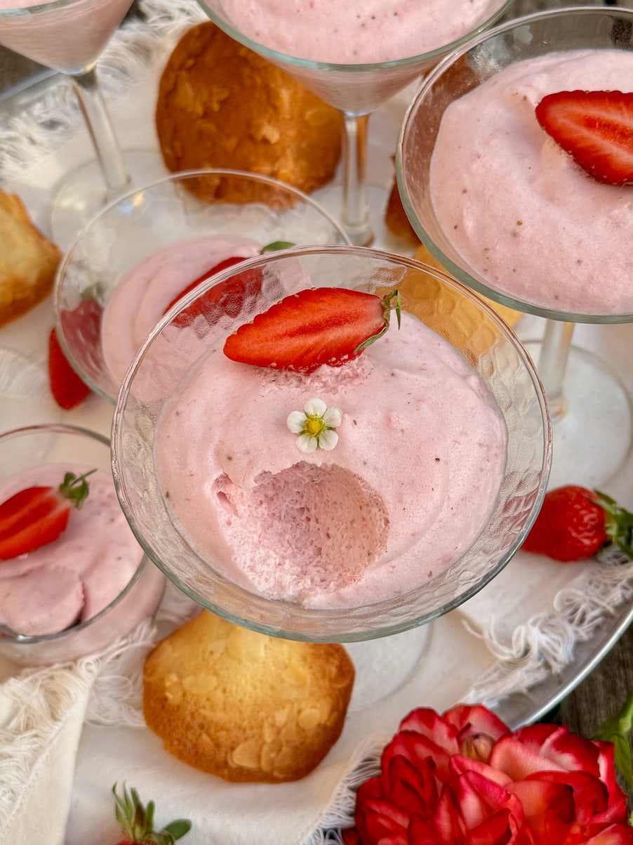 large stem glasses with strawberry mousse showing an airy texture and served with French almond cookies