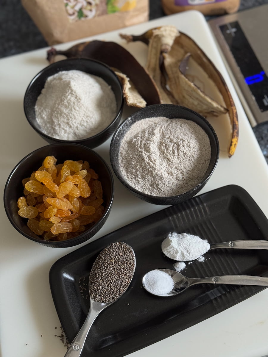 simple ingredients for gluten free muffins with 2 ripe bananas, rice flour, buckwheat, golden raisins, chia seeds, baking powder and soda