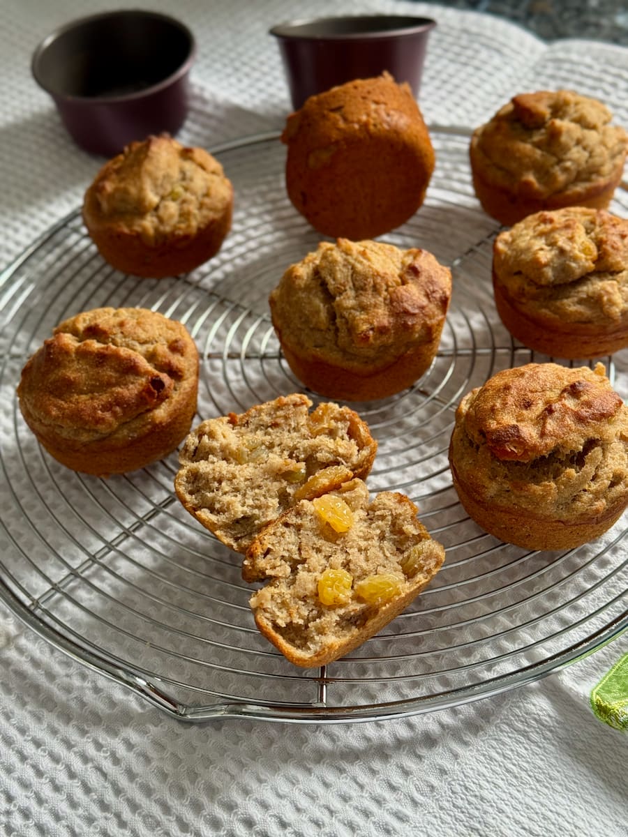 banana muffins with golden raisins showing a soft crumb on a cooling rack, and made with chestnut flour