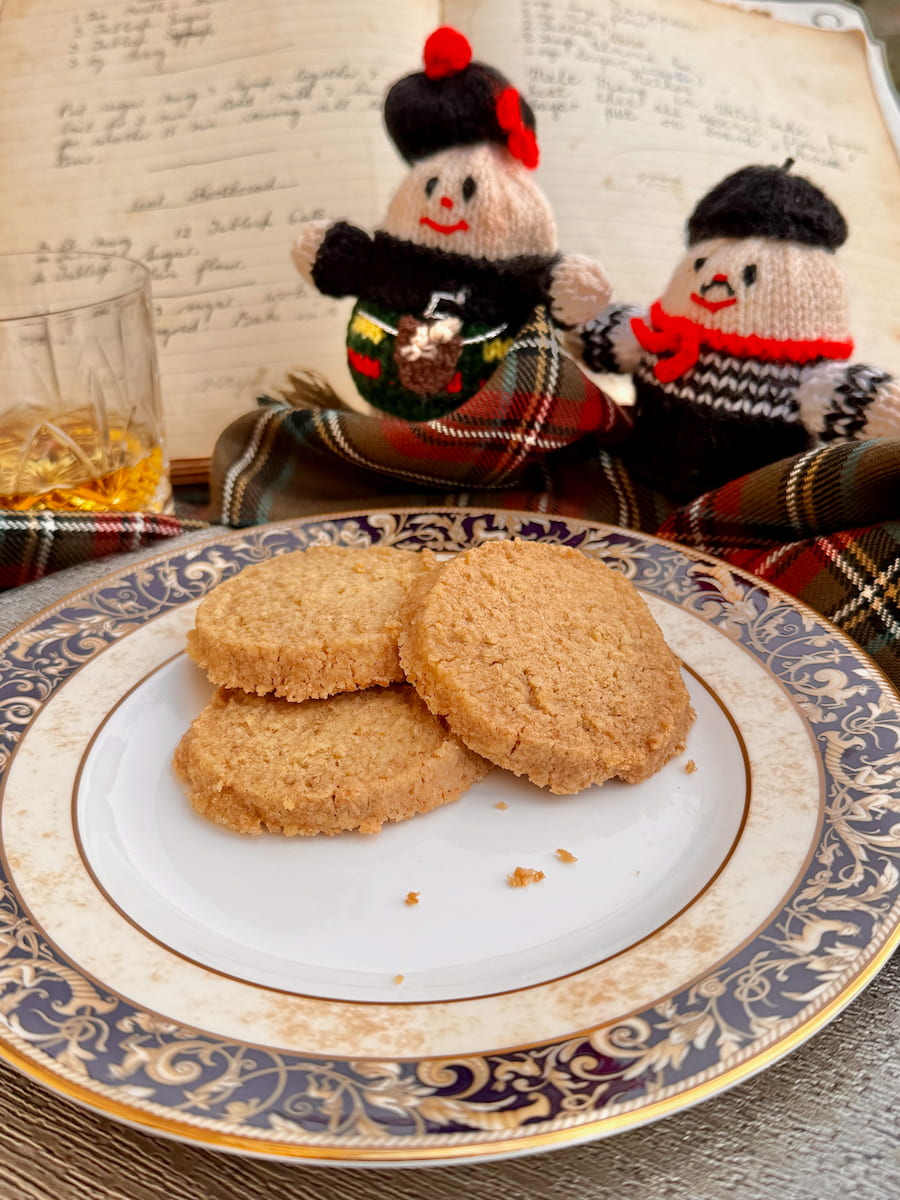 Scottish oat shortbread, gluten free served with a Dram of Scottish Whisky, Stuart tartan and two knitted haggis of a Scot and a Frenchman