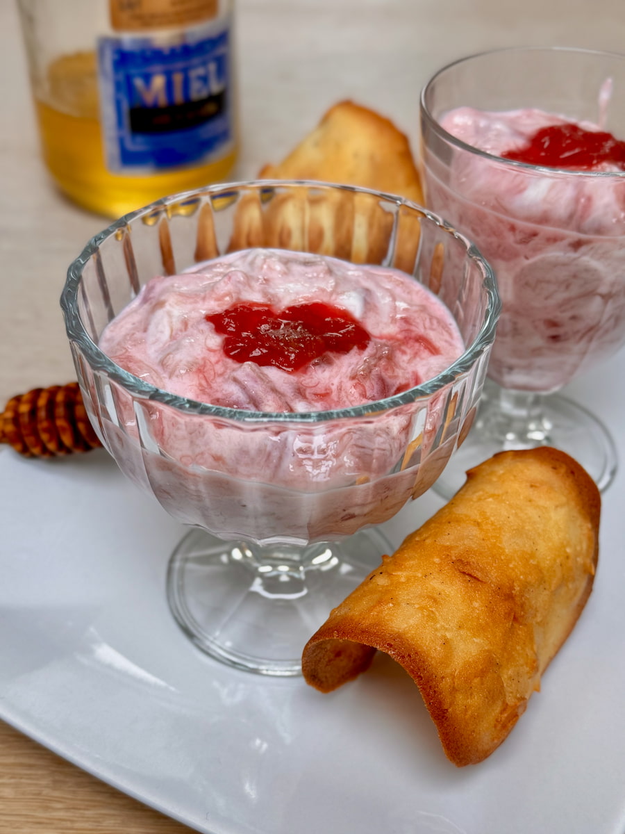 Healthy rhubarb fool recipe served with almond tuiles with a pot of French honey in the background