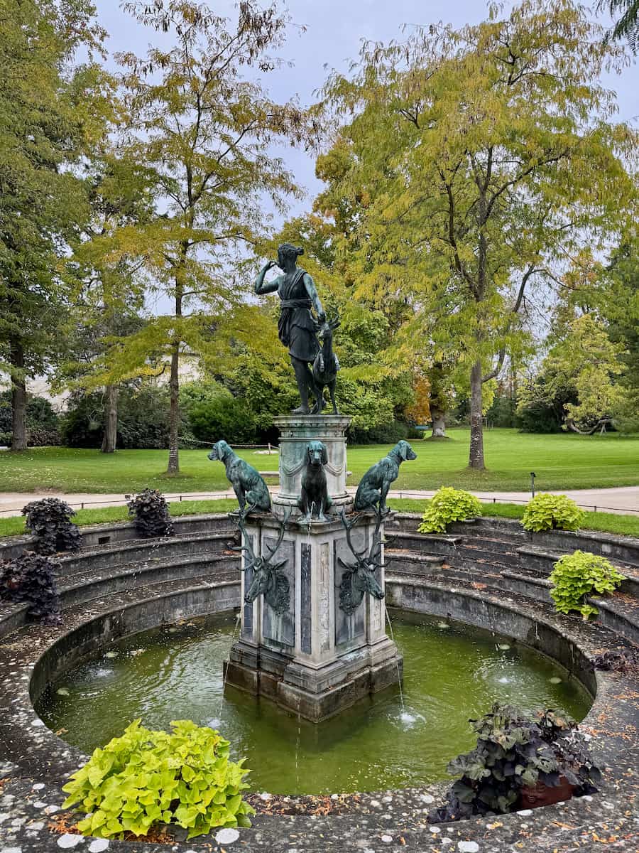 Diana fountain in the gardens of Fontainebleau with dog and stag statues