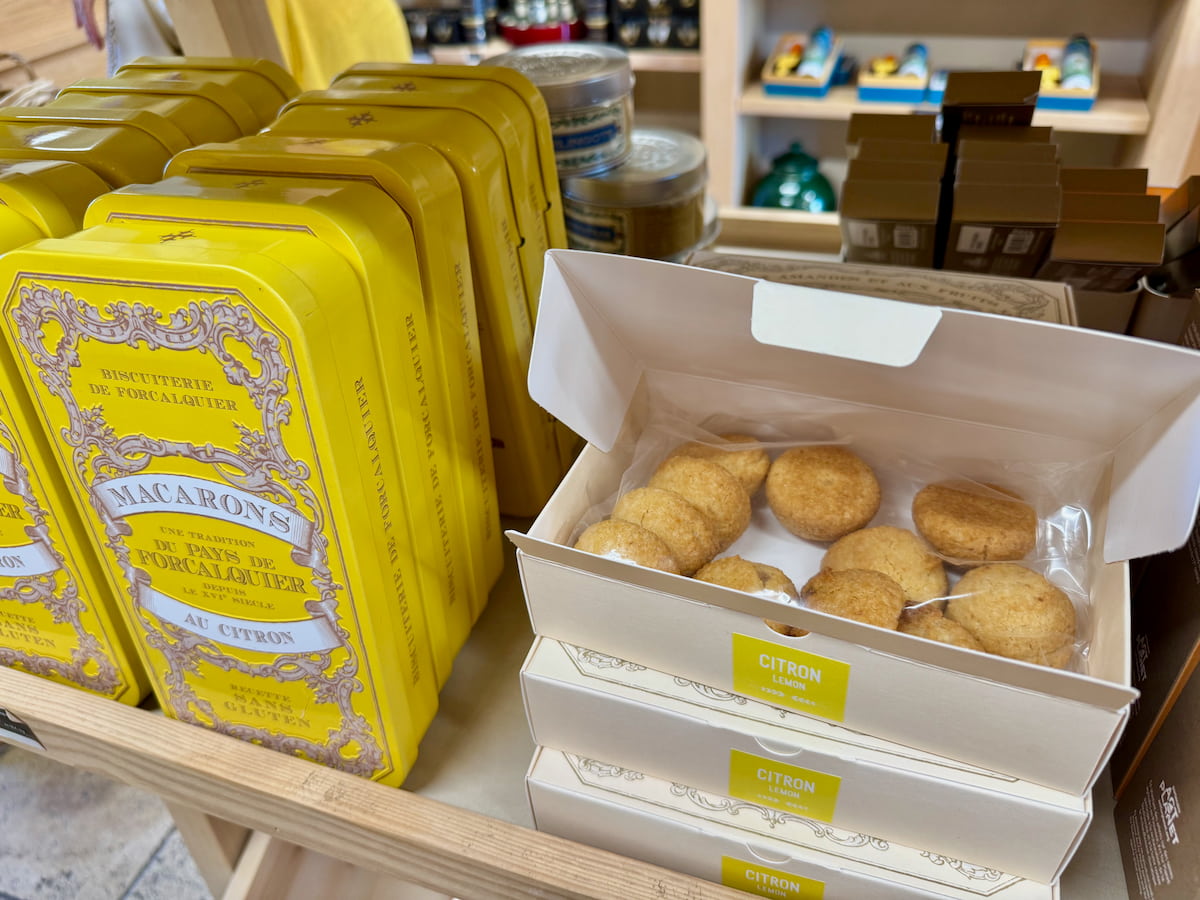 Bright yellow tin boxes filled with rounded mounds of almond cookies flavoured with lemon in Forcalquier in Provence