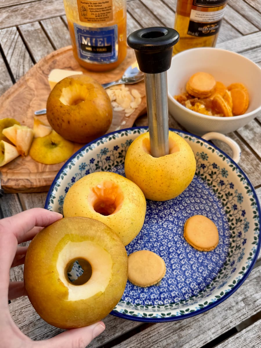 coring large cooking apples with an apple corer right to the bottom - to bake and stuff with dried fruits