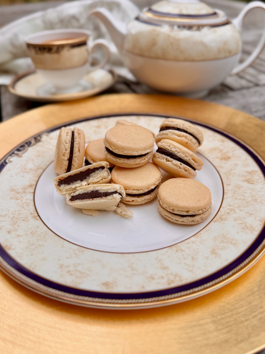 a stack of plain ivory shells with dark chocolate ganache, soft matured interior visible