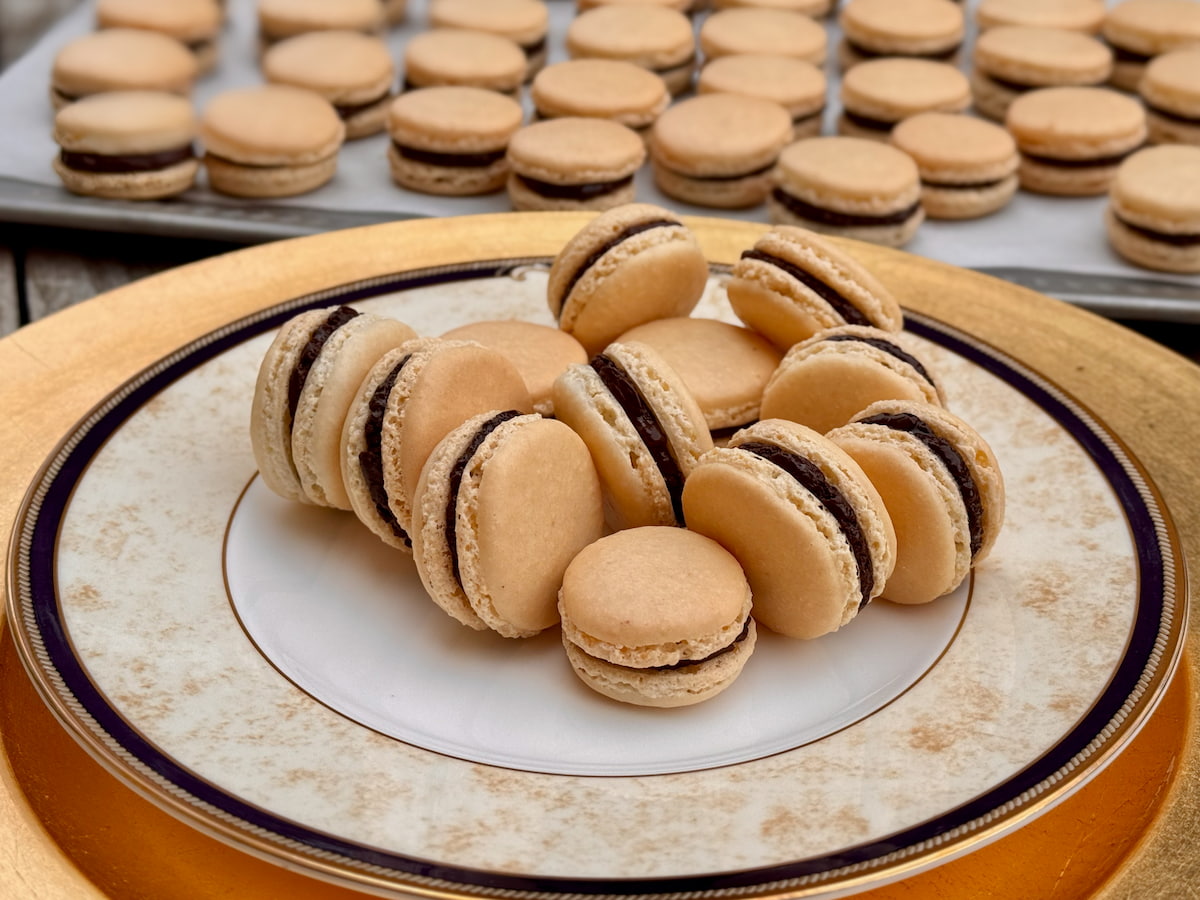 French macarons using French meringue without colouring and filled with a dark chocolate ganache